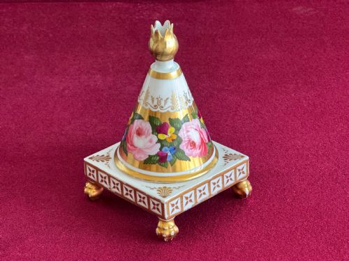 fig 1. A conical Regency porcelain pastille burner decorated with hand-painted pink roses and pansies on a square gilded pedestal with claw feet.