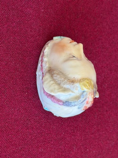 fig 1. An 18th-century Chelsea soft-paste porcelain bonbonniere sculpted as a female head wearing a bonnet with polychrome enamel finish.