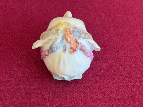 fig 2. An 18th-century Chelsea soft-paste porcelain bonbonniere sculpted as a female head wearing a bonnet with polychrome enamel finish.