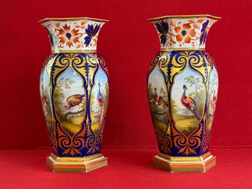 fig 1. A pair of Regency period Flight, Barr & Barr Worcester porcelain vases featuring cobalt blue ground, heavy gold scrollwork, and painted exotic bird reserves.
