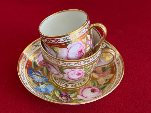 fig 1. A Regency John Rose Coalport porcelain trio comprising a teacup, coffee can, and matching saucer featuring hand-painted pink roses on a gold ground.