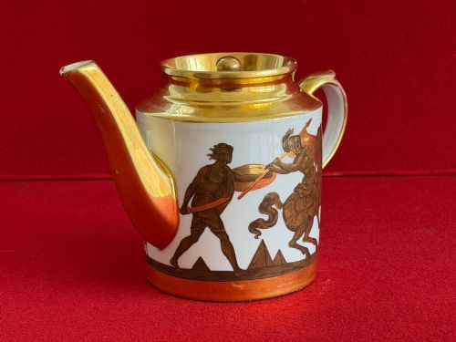 fig 1. A Regency cylindrical porcelain teapot featuring a gilded spout and collar alongside hand-painted classical figures on a white ground.