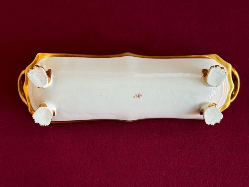 fig 1. A Regency porcelain pen tray featuring a hand-painted playing card motif on a black background, framed by twin gilded handles.