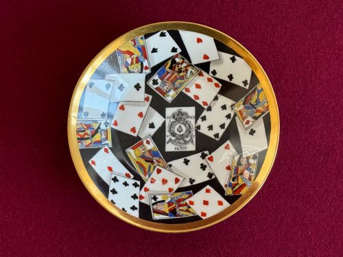 fig 2. An early nineteenth-century porcelain teacup decorated with terracotta classical foliage alongside a saucer painted with a trompe loeil playing card pattern.