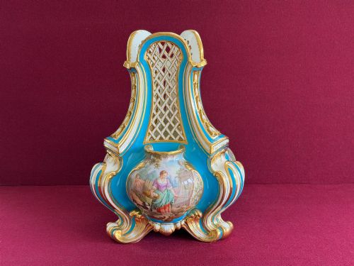 fig 2. A Victorian Minton porcelain Sevres style vase featuring vibrant turquoise bleu celeste glaze, a reticulated lattice back, gilded Rococo scroll mouldings, and a hand-painted central pastoral scene.