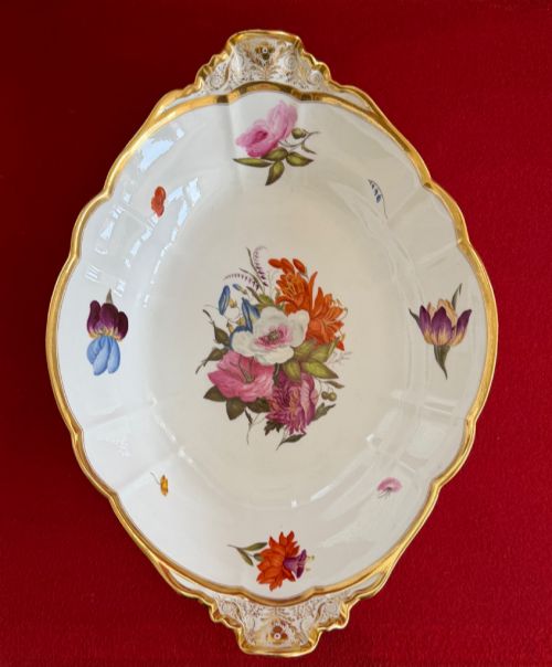 fig 1. An oval lobed white porcelain centrepiece dish with gilded handles and borders, featuring hand-painted botanical floral sprays.