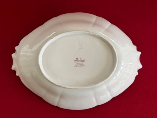 fig 2. An oval lobed white porcelain centrepiece dish with gilded handles and borders, featuring hand-painted botanical floral sprays.