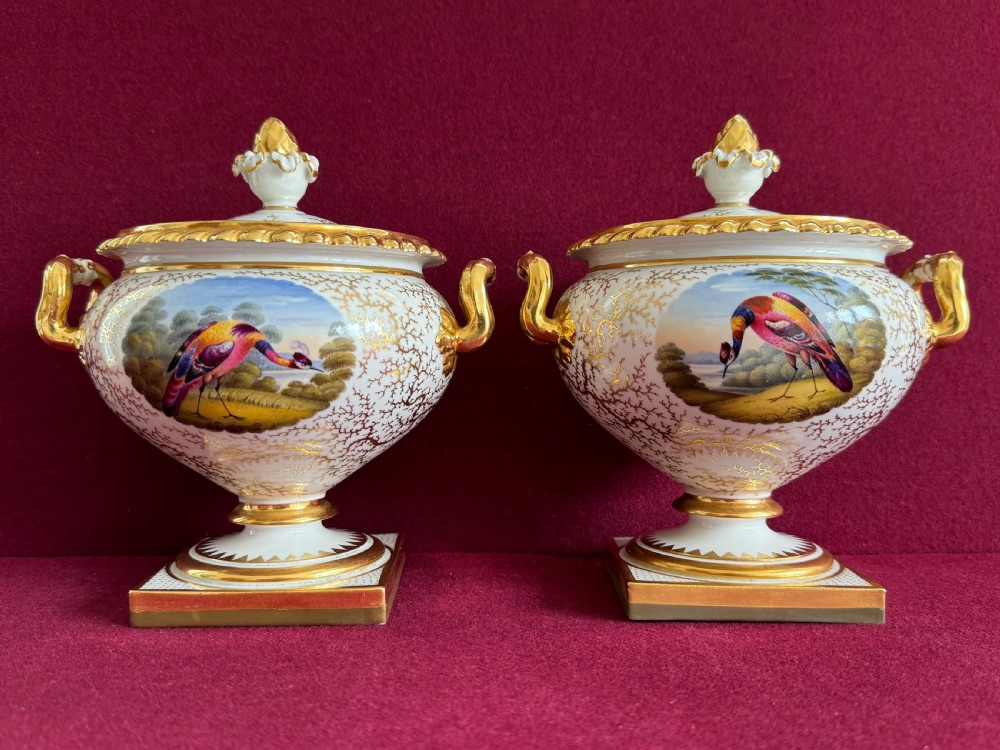 A pair of Regency Flight, Barr & Barr Worcester porcelain cream tureens featuring hand-painted bird panels, gilt seaweed pattern ornamentation, twin handles, and square plinth bases. View XI
