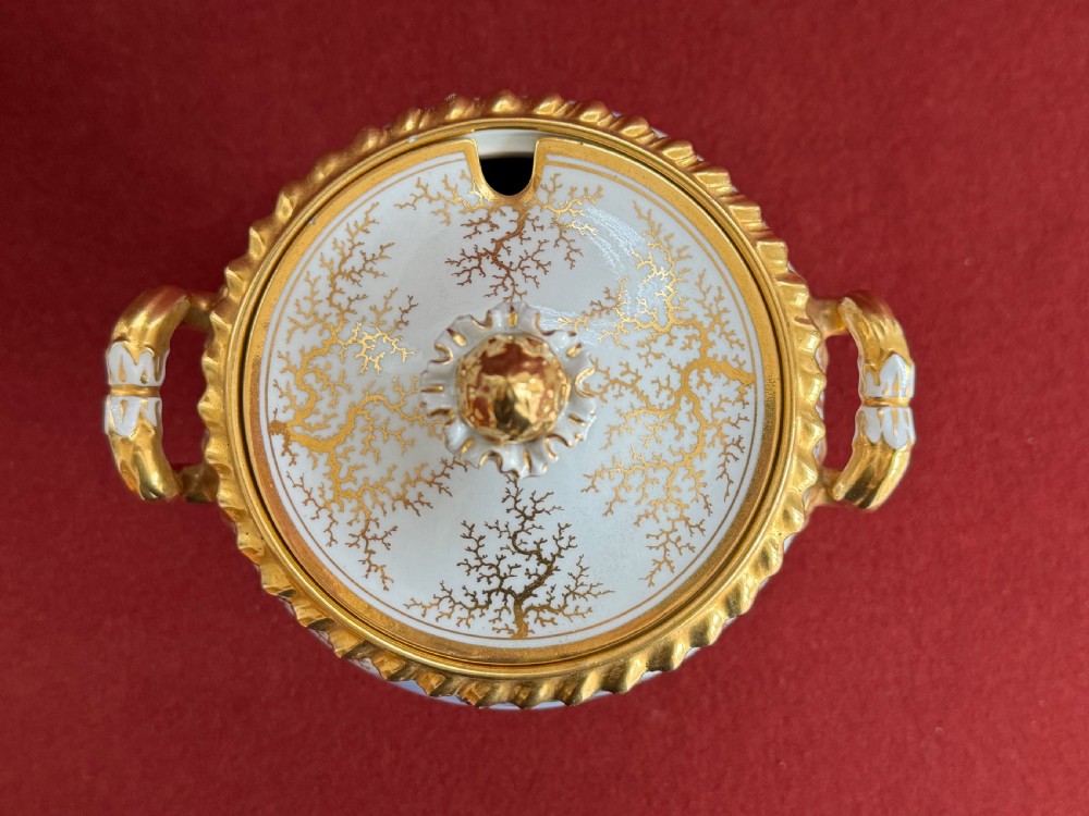 A pair of Regency Flight, Barr & Barr Worcester porcelain cream tureens featuring hand-painted bird panels, gilt seaweed pattern ornamentation, twin handles, and square plinth bases. View V