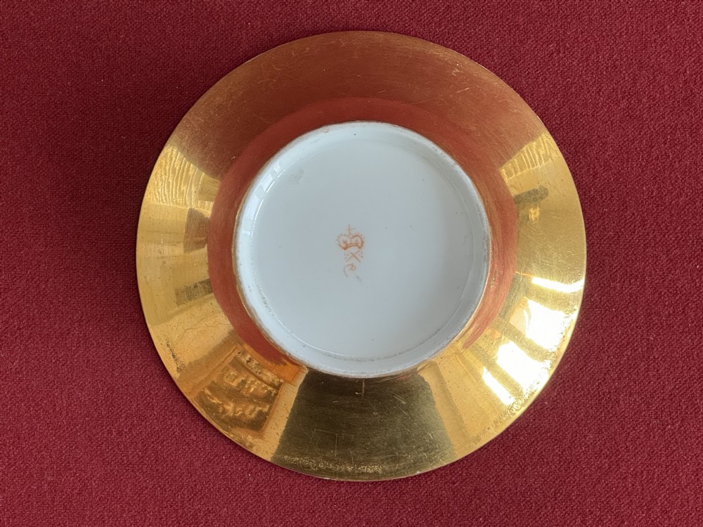 An antique Regency period porcelain teacup and matching saucer featuring a hand-painted playing card motif on the interior and a gilded exterior finish. View IV