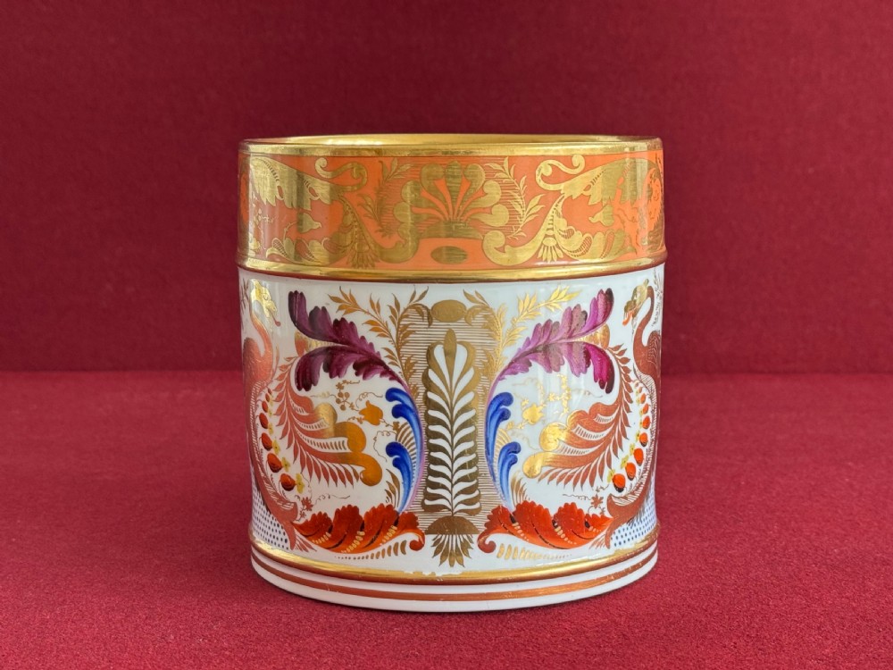 A Regency Derby porcelain porter mug featuring hand painted bird motifs, an orange gilded upper border, and an angular handle. View II