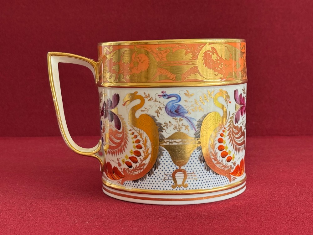 A Regency Derby porcelain porter mug featuring hand painted bird motifs, an orange gilded upper border, and an angular handle. View III