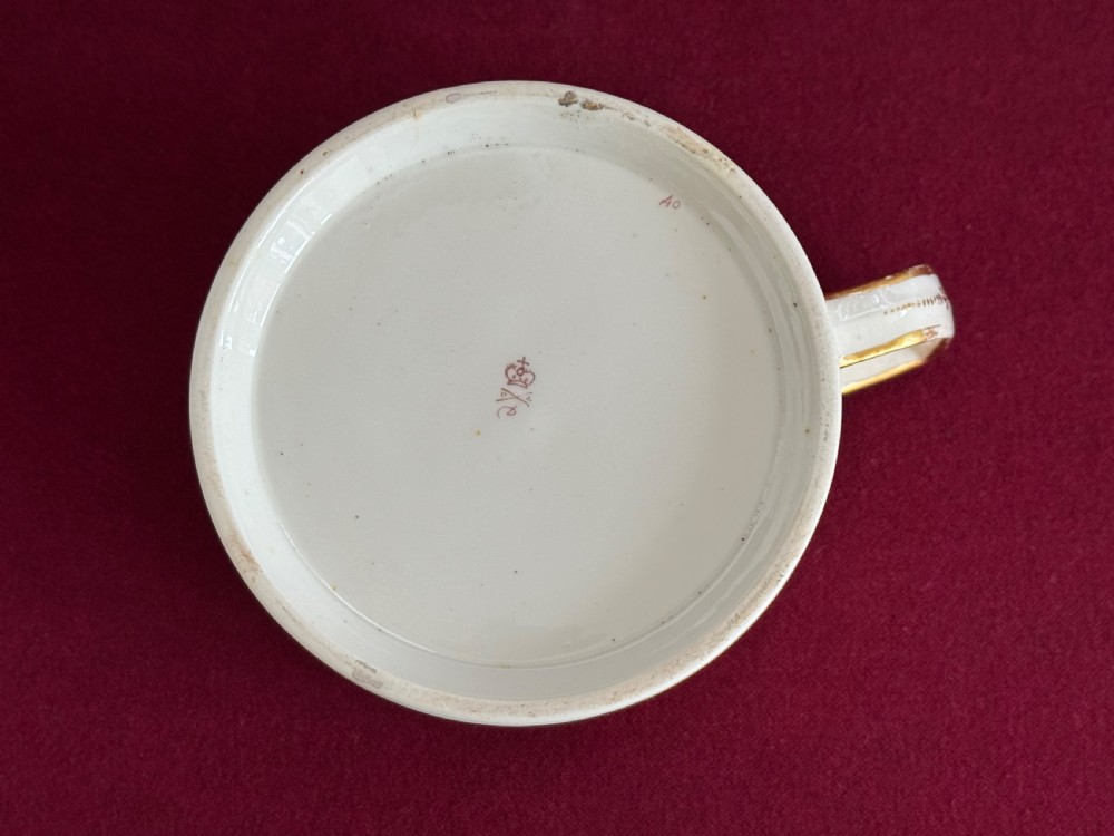 A Regency Derby porcelain porter mug featuring hand painted bird motifs, an orange gilded upper border, and an angular handle. View V