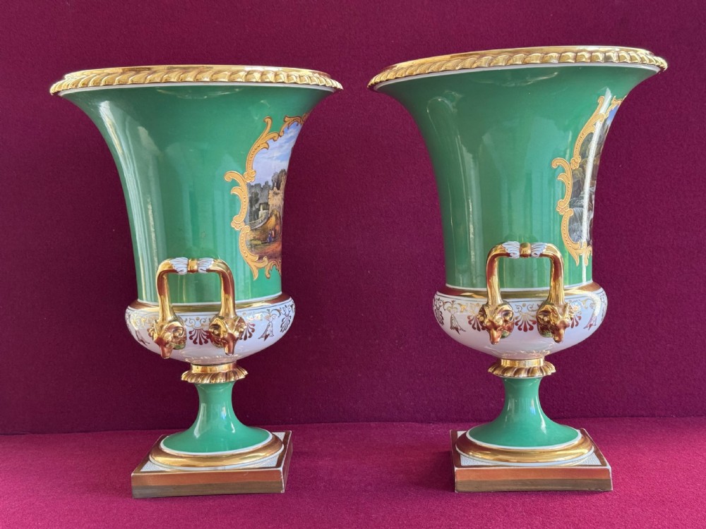 A pair of Regency porcelain urn vases featuring apple green grounds, gilt goat-head handles, and central hand-painted landscape scenes. View VIII