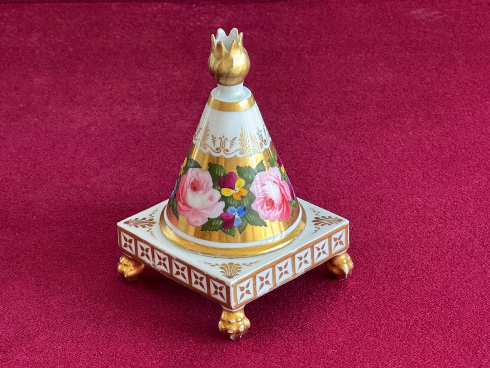 A conical Regency porcelain pastille burner decorated with hand-painted pink roses and pansies on a square gilded pedestal with claw feet. View II