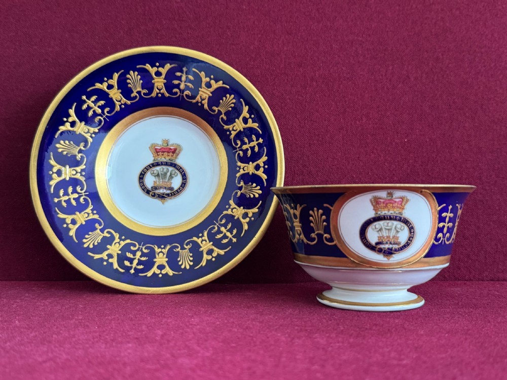 A Flight, Barr and Barr Worcester porcelain cup and saucer featuring cobalt blue ground, gilt palmette borders, and the Prince of Wales crest.