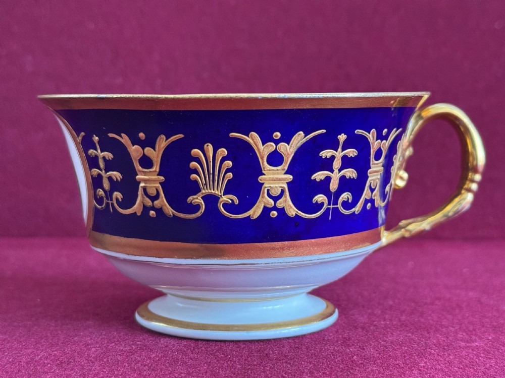 A Flight, Barr and Barr Worcester porcelain cup and saucer featuring cobalt blue ground, gilt palmette borders, and the Prince of Wales crest. View VII
