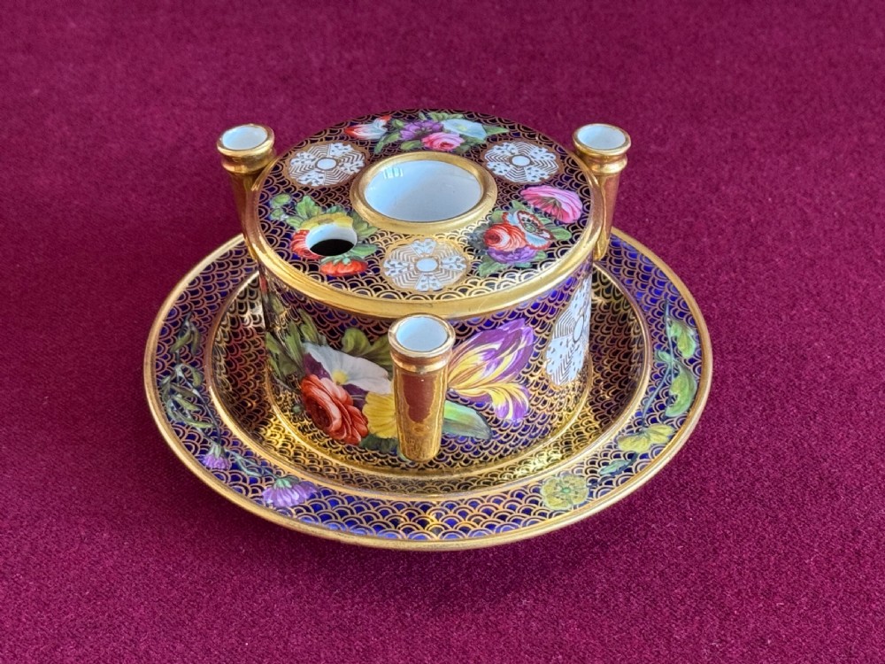 An early 19th-century circular English porcelain inkstand featuring gold scale gilding on a dark blue ground, floral reserves, and three cylindrical quill holders. View IV