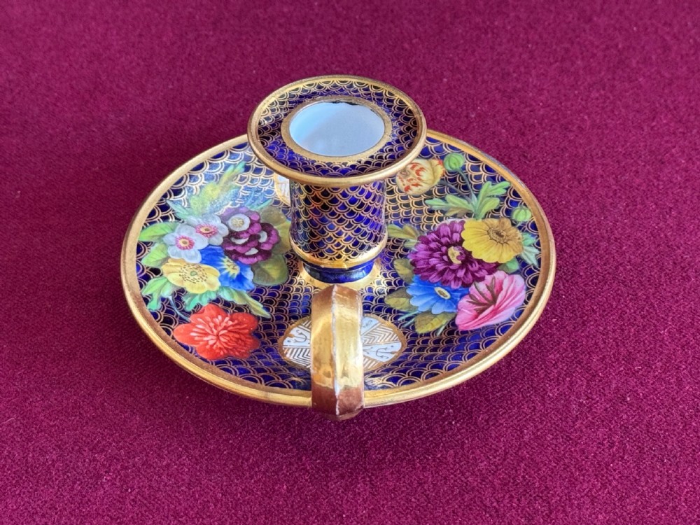 A Regency period Spode porcelain chamber candlestick decorated with a cobalt blue scale pattern, gilt trim, and hand-painted floral panels. View IV