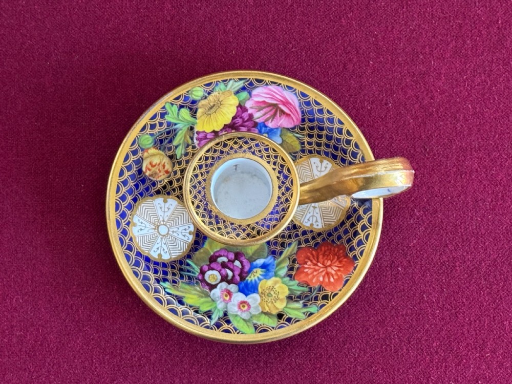 A Regency period Spode porcelain chamber candlestick decorated with a cobalt blue scale pattern, gilt trim, and hand-painted floral panels. View V