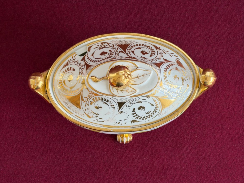 A Regency John Rose Coalport porcelain sauce tureen decorated with hand-painted flowers, gilded scroll handles, and a matching lid. View V