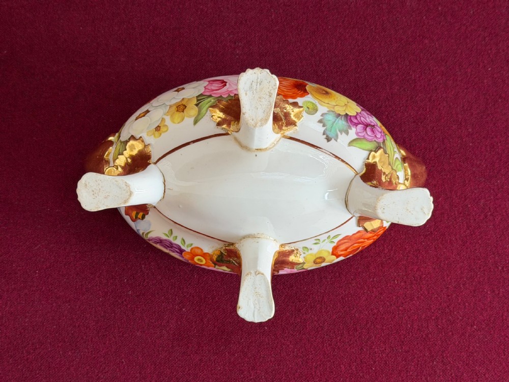 A Regency John Rose Coalport porcelain sauce tureen decorated with hand-painted flowers, gilded scroll handles, and a matching lid. View VI