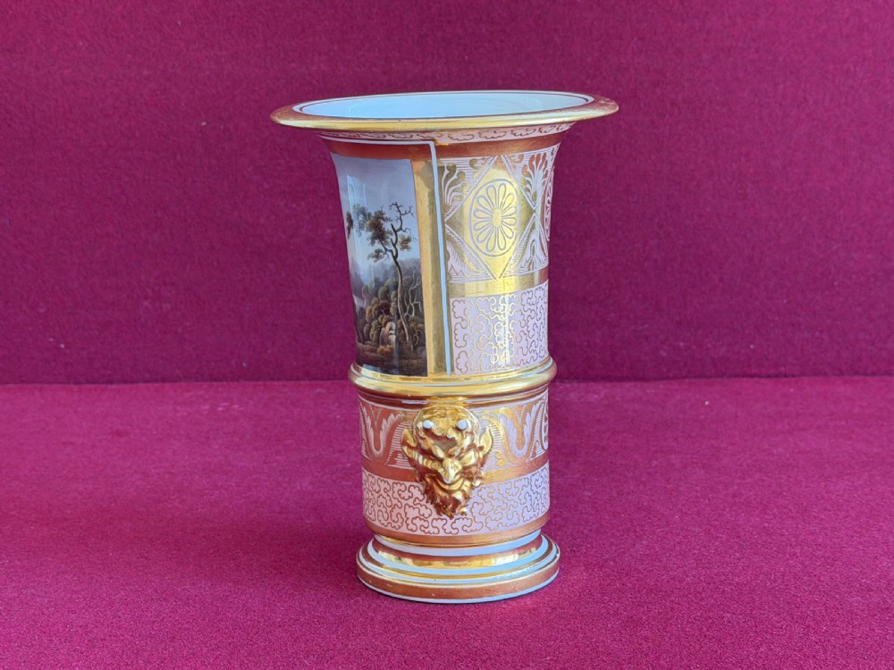 A Regency Barr, Flight and Barr Worcester porcelain spill vase featuring a hand-painted landscape panel of Ballyhooly Castle, gold lion-mask side handles, and gilt classical ornamentation. View II