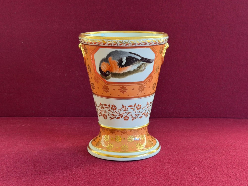A Regency Barr, Flight and Barr Worcester porcelain jardiniere decorated with an orange ground, gilt stars, and a hand-painted panel depicting a bird.