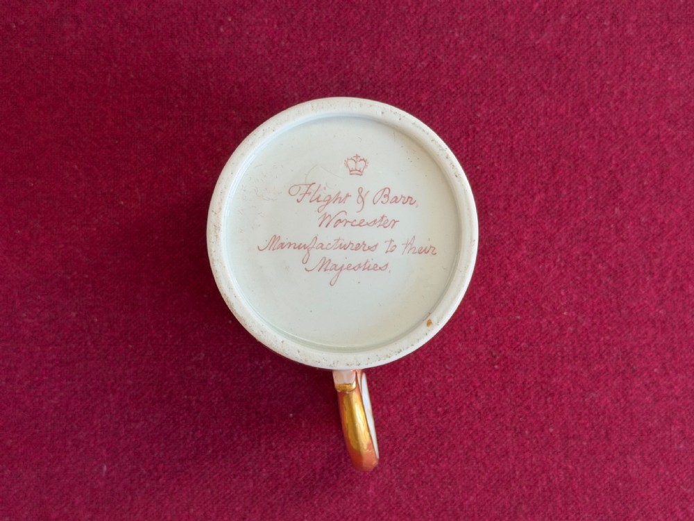 A Georgian Flight and Barr Worcester porcelain coffee can and saucer with hand-painted sepia landscape vignettes and gilt star patterning on a peach border. View IV