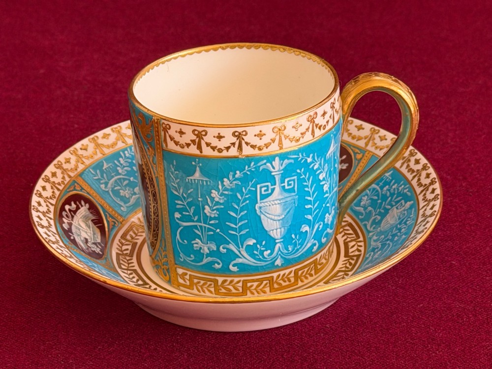 A Victorian Minton porcelain coffee can and saucer decorated with rich turquoise enamel, Neoclassical motifs, classical figure cameos, and gold leaf gilding. View III