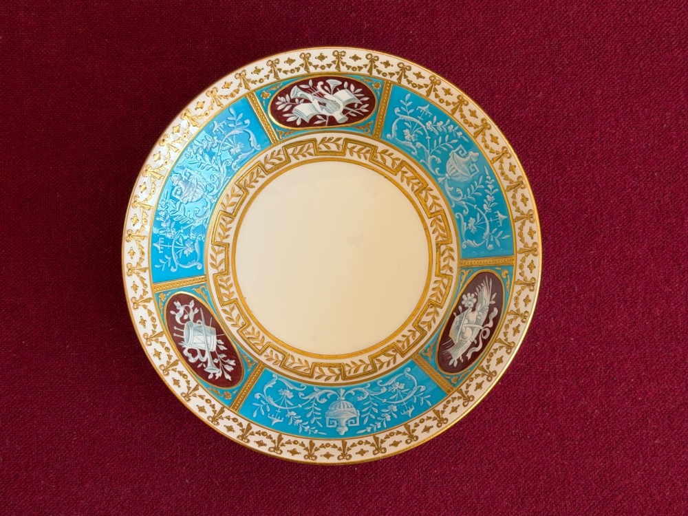 A Victorian Minton porcelain coffee can and saucer decorated with rich turquoise enamel, Neoclassical motifs, classical figure cameos, and gold leaf gilding. View VI