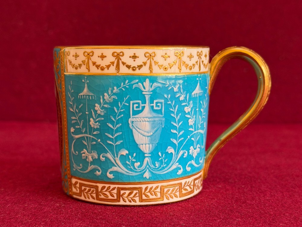 A Victorian Minton porcelain coffee can and saucer decorated with rich turquoise enamel, Neoclassical motifs, classical figure cameos, and gold leaf gilding. View XI