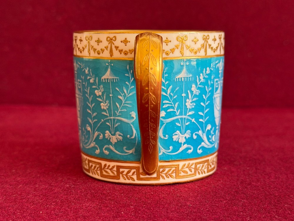 A Victorian Minton porcelain coffee can and saucer decorated with rich turquoise enamel, Neoclassical motifs, classical figure cameos, and gold leaf gilding. View XII