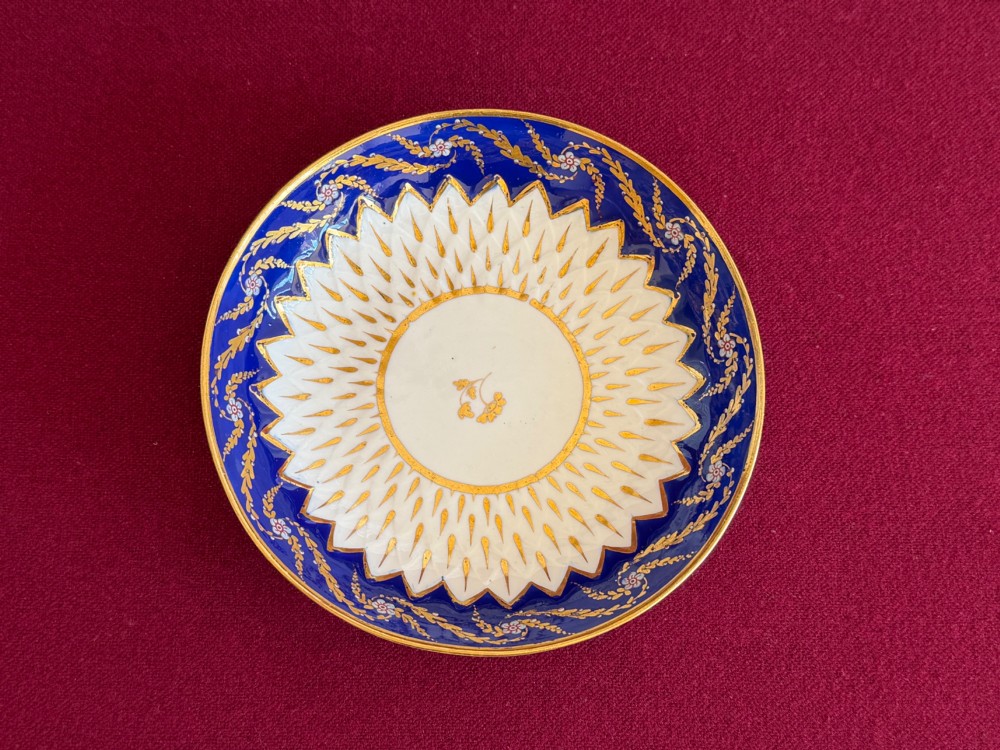 An eighteenth-century Chelsea Derby porcelain trio comprising a coffee cup, tea bowl, and saucer decorated in cobalt blue and gold leaf pattern 34. View II