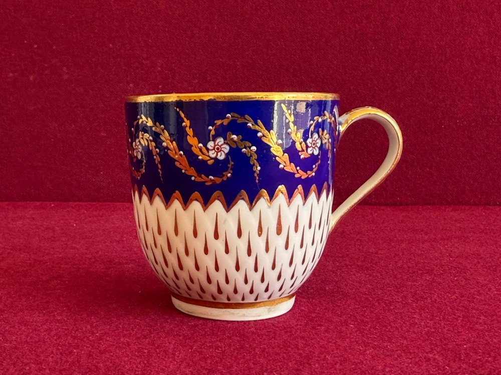 An eighteenth-century Chelsea Derby porcelain trio comprising a coffee cup, tea bowl, and saucer decorated in cobalt blue and gold leaf pattern 34. View IV