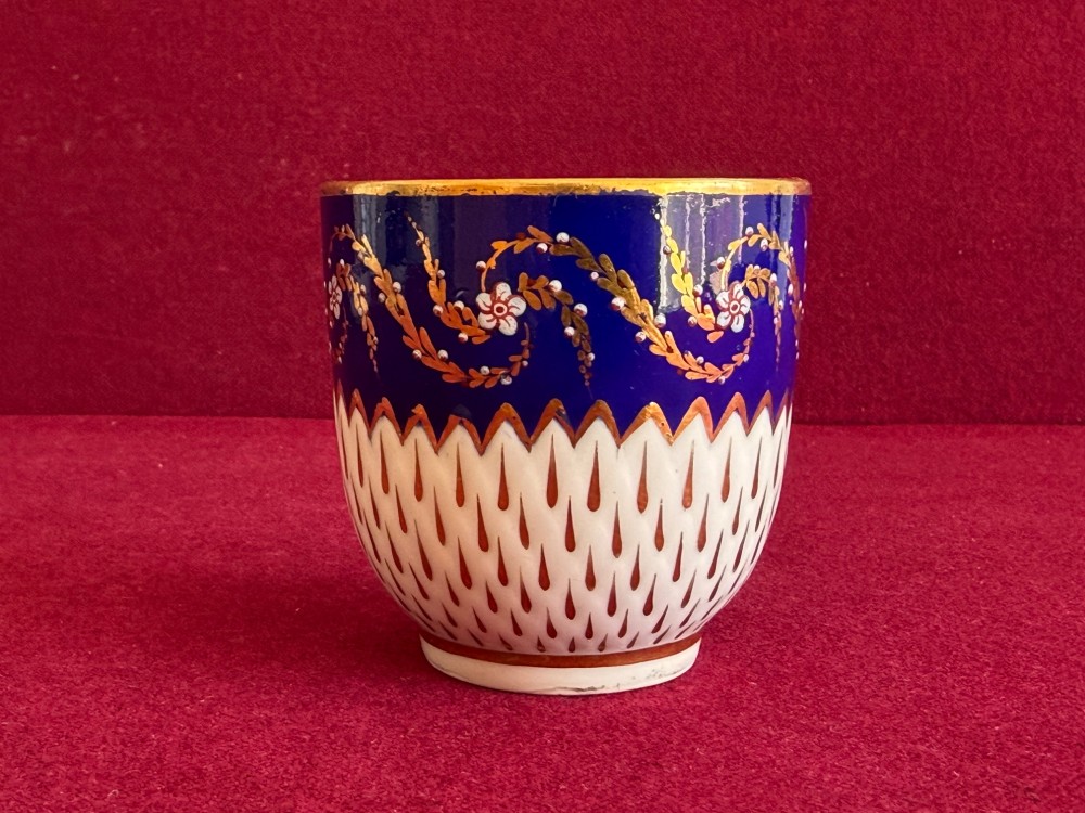 An eighteenth-century Chelsea Derby porcelain trio comprising a coffee cup, tea bowl, and saucer decorated in cobalt blue and gold leaf pattern 34. View V