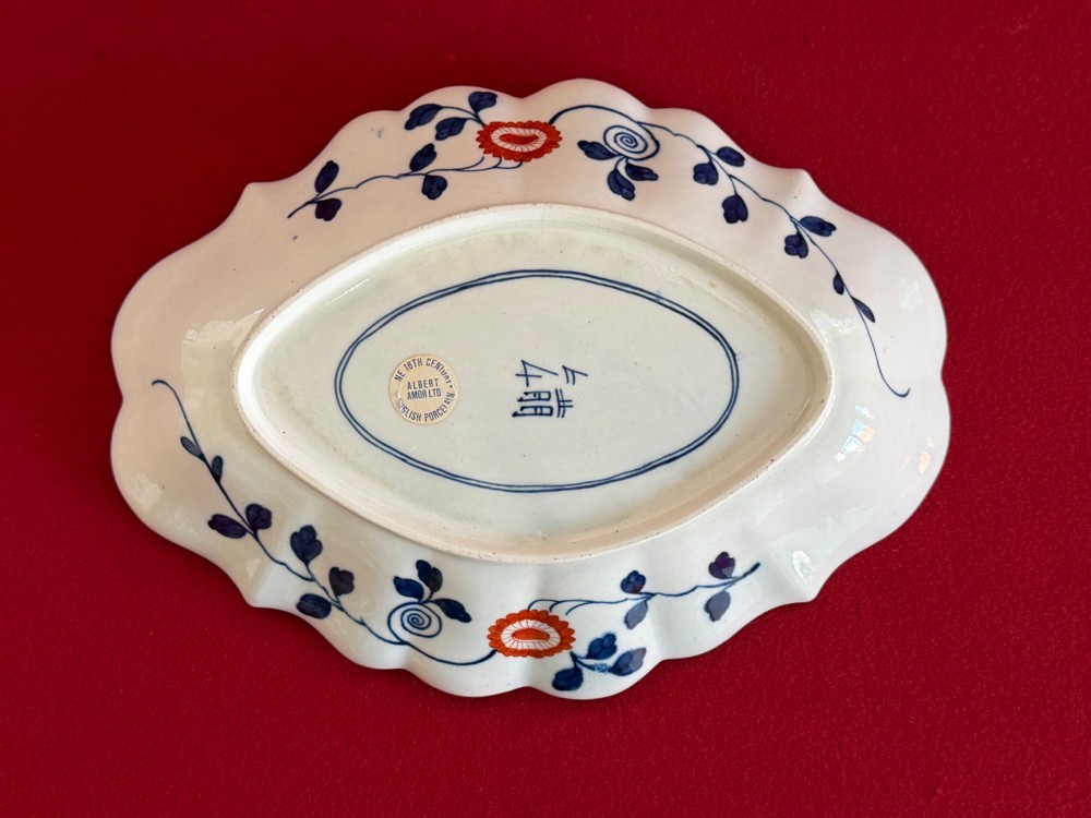 An 18th-century oval scalloped soft-paste porcelain dessert dish featuring hand-painted Japanese fan motifs in cobalt blue, iron red, green, and gilding. View II