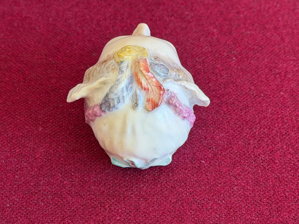 An 18th-century Chelsea soft-paste porcelain bonbonniere sculpted as a female head wearing a bonnet with polychrome enamel finish. View III