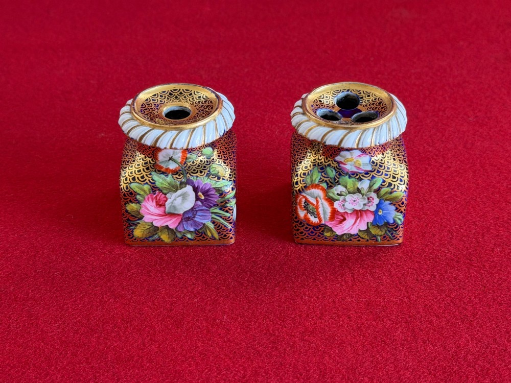 A Regency porcelain inkstand featuring elaborate gilding over a dark blue ground with polychrome floral panels and a central handle. View VIII