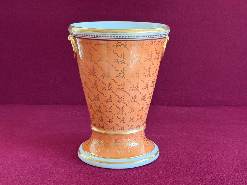 A Regency Flight & Barr Worcester porcelain jardiniere featuring an orange ground, gilt seaweed patterning, and a classical female figure painted in grisaille inside a oval frame. View V