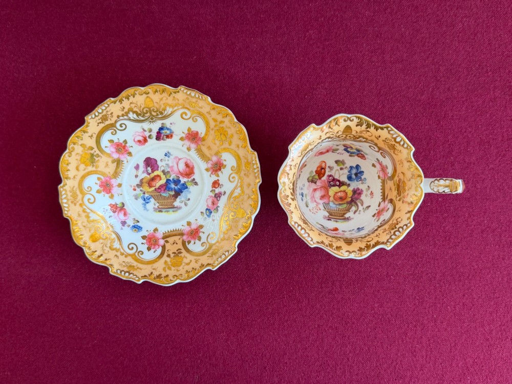 A Regency period H and R Daniel porcelain trio comprising a teacup, coffee cup, and saucer decorated with gilded scrolling borders and hand-painted floral sprigs. View III