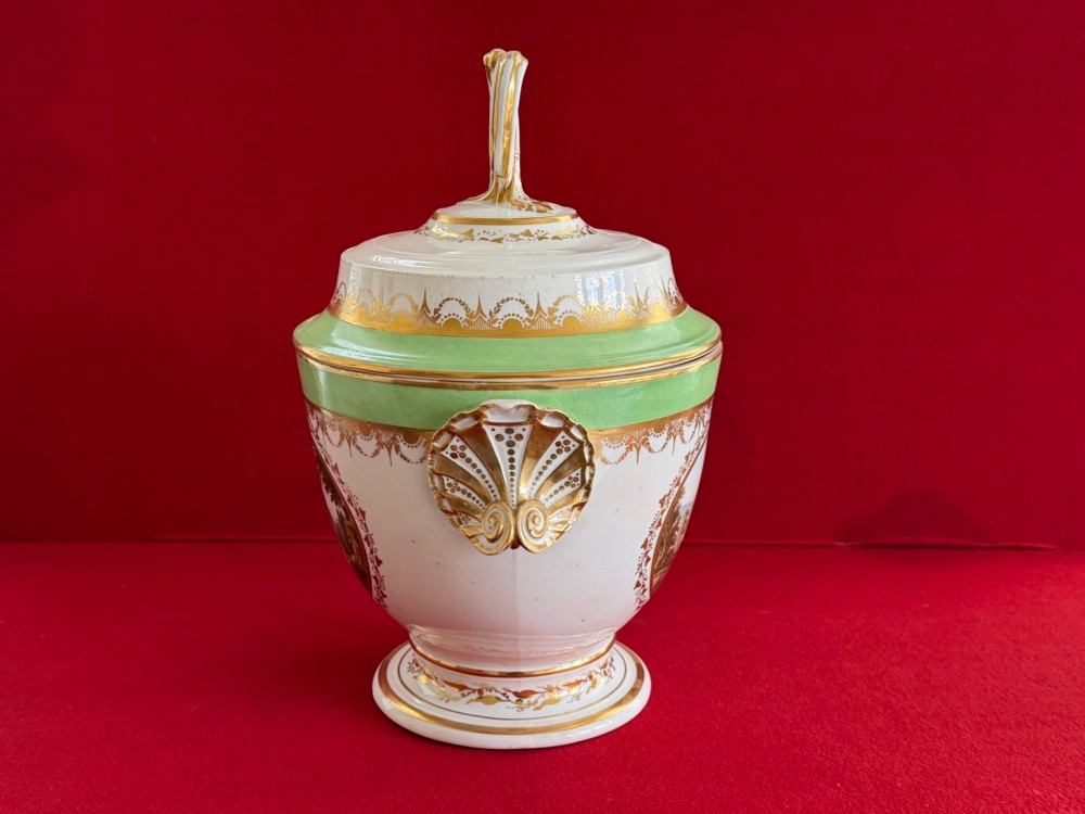 A late 18th-century Derby porcelain ice pail with twin scroll handles, a looping lid finial, an apple-green band, gold gilding, and a central oval landscape painting. View IV
