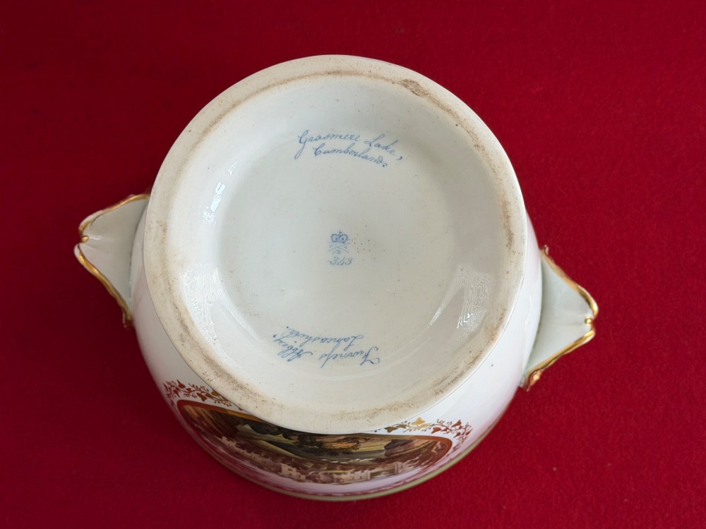 A late 18th-century Derby porcelain ice pail with twin scroll handles, a looping lid finial, an apple-green band, gold gilding, and a central oval landscape painting. View V