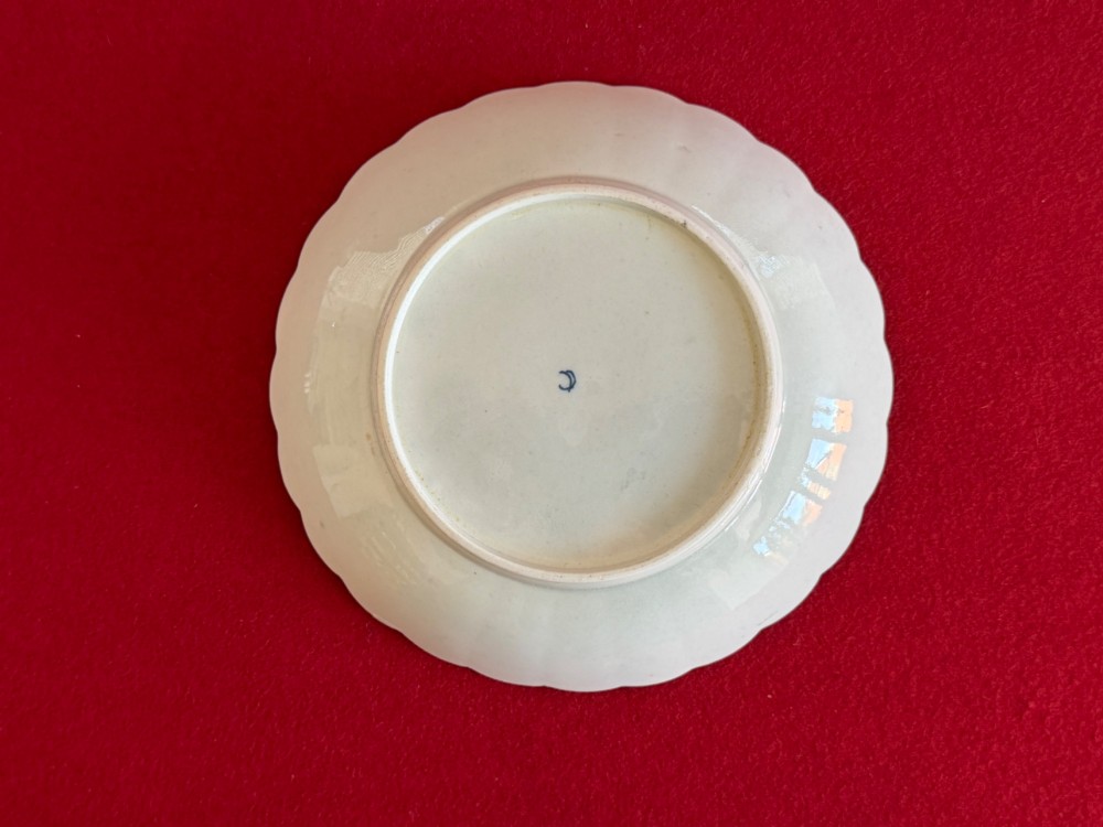 An 18th-century Worcester porcelain trio comprising a teacup, coffee cup, and saucer decorated with fluted moulding, blue swags, Classical urn motifs, and gold leaf gilding. View VI