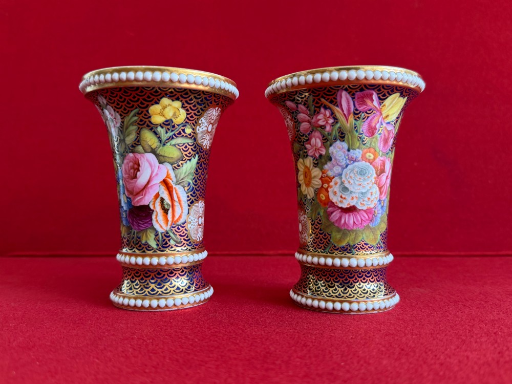 A pair of flared Regency Spode porcelain spill vases decorated with dark blue gilded fishscale patterns, colourful hand-painted floral panels, and white beaded borders. View IV