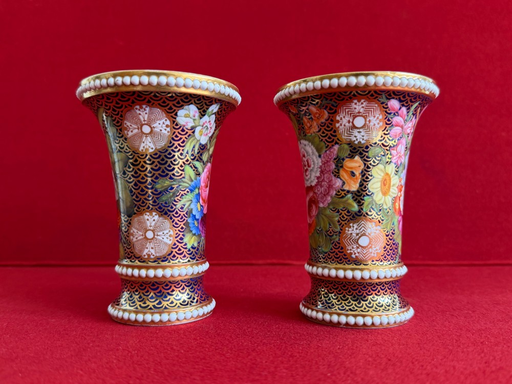 A pair of flared Regency Spode porcelain spill vases decorated with dark blue gilded fishscale patterns, colourful hand-painted floral panels, and white beaded borders. View V