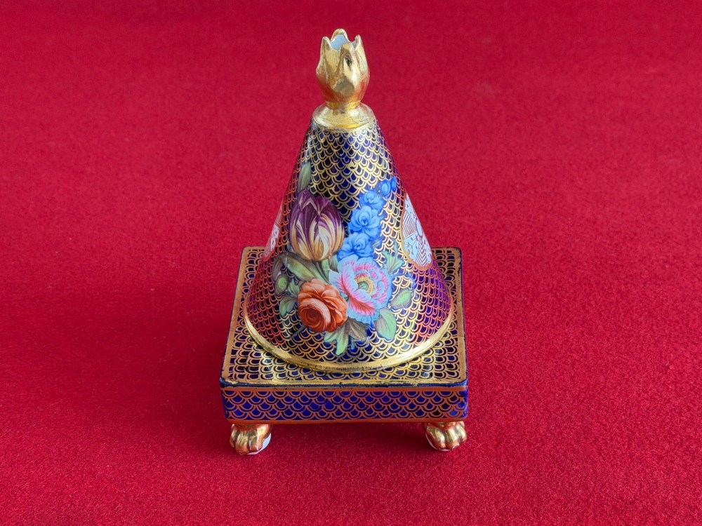 A conical Regency Spode porcelain pastille burner featuring cobalt blue scale gilding, hand-painted floral panels, and gilt paw feet on a square pedestal base.