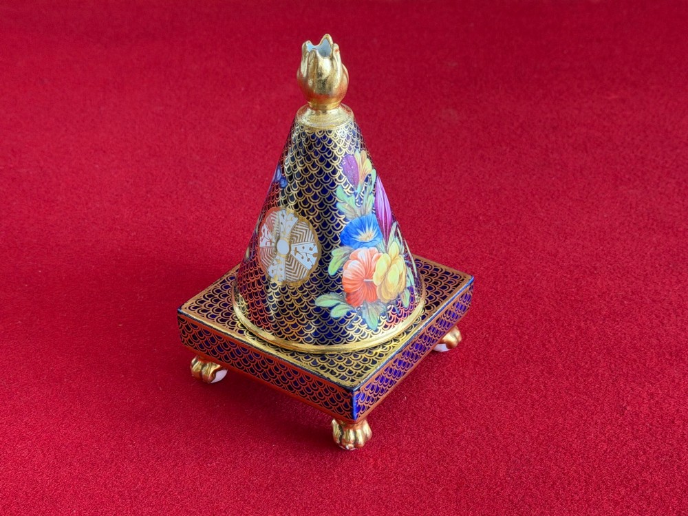A conical Regency Spode porcelain pastille burner featuring cobalt blue scale gilding, hand-painted floral panels, and gilt paw feet on a square pedestal base. View V