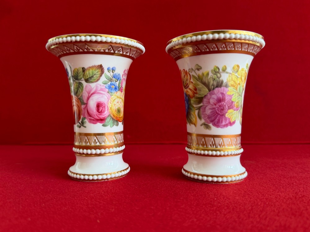 A pair of flared white antique porcelain spill vases painted with colourful floral bouquets and trimmed with gilded geometric borders and beaded rims. View III