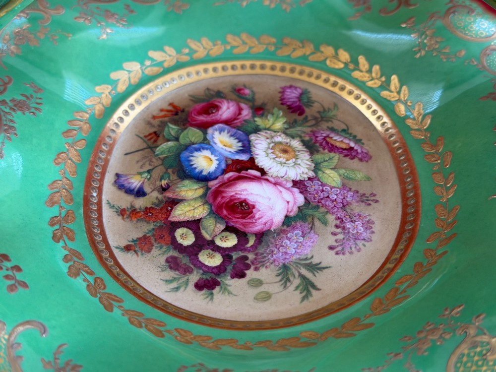 An antique green porcelain basket featuring a central hand-painted floral bouquet, gilt scrolling filigree, and a gilded branch handle. View III